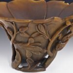 A Sydney shopper bought a carved cup for A at a thrift shop; experts identified it as a centuries-old Chinese rhinoceros-horn cup, and was auctioned for A,640 in 2013