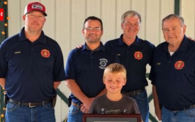 An 8-year-old Indiana boy spotted a smoking camper trailer and alerted people nearby before it caught fire; he was honoured with Department Patch and Certificate of Recognition for preventing a larger emergency